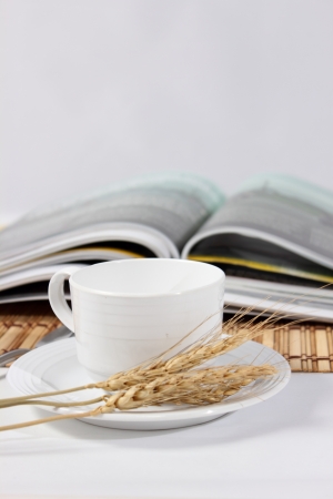  magazines and white cup of coffee on white background.の写真素材