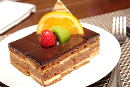 A chocolate layer cake decorated with fruit