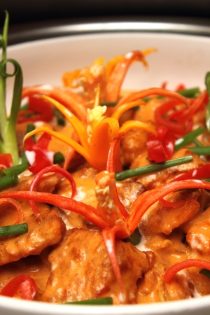  bowl of curry chicken cooked with coconut milk with chilli garnishingの写真素材