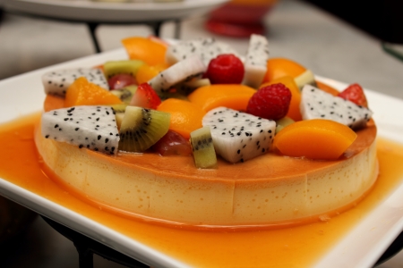 a Deliciuos caramel custard close shot with fresh fruitの写真素材