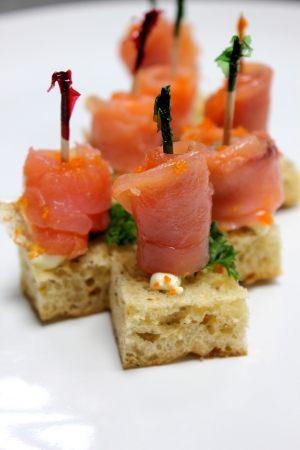 Smoked salmon and cream cheese canape garnished with herbsの写真素材