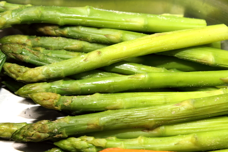 Plate of cooked asparagus on a whte backgroundの写真素材