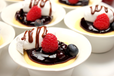 Blueberry cheesecakes served in smallcup and fresh raspberryの写真素材