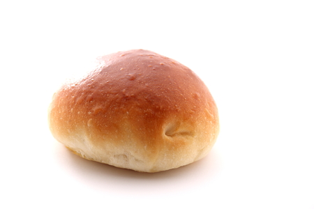 A fresh bread roll with white bakgrondの写真素材