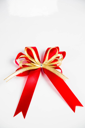 red ribbon with bow isolated on white.の写真素材
