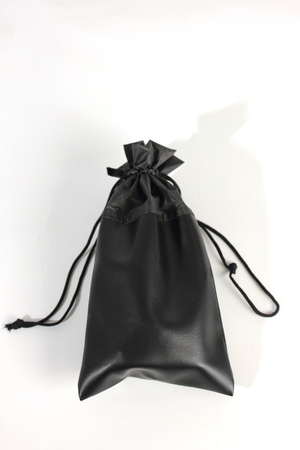 Black  bag packaging isolated over white backgroundの写真素材