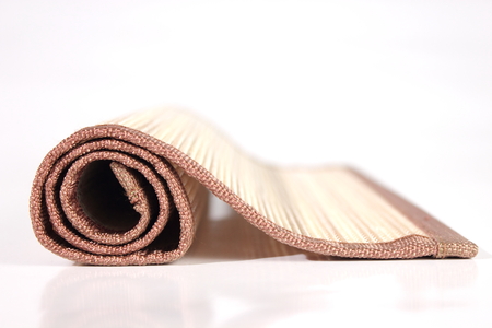 Wooden table mat - natural on white background.の写真素材