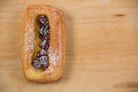 A Raisin Danish tasty pastron wood backgroundの写真素材