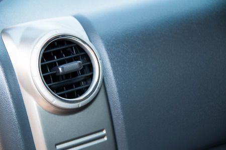 Closeup of an air vent for controlling airflow in an automobile.の写真素材