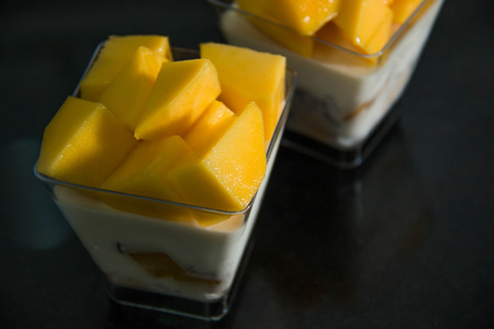 Delicious dessert with mango mousse in cup.の写真素材