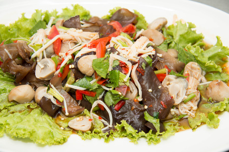 Spicy mushroom salad on plate, Thai food style.の写真素材