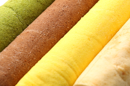 swiss  cream Roll cake on white background.の写真素材