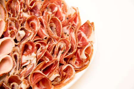 Plate with cold slices meat  on  whiteの写真素材