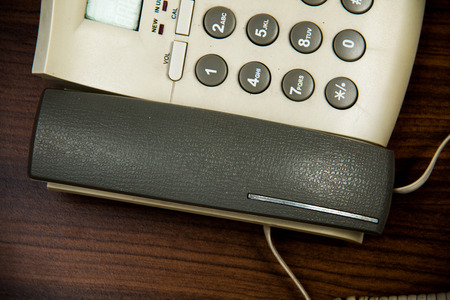 A home  phone on a wood  background.