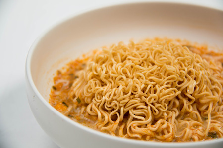 Instant noodles in dish on white background.の写真素材