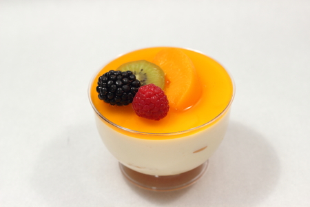 Delicious peach mousse in glass, white fresh fruitの写真素材