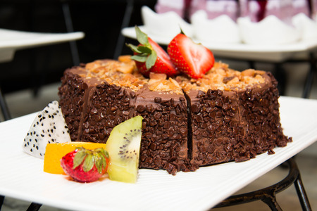 Chocolate cakes with strawberry and kiwi on topの写真素材