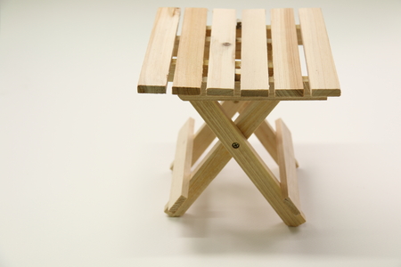 A Wooden folding stool  on white background.の写真素材