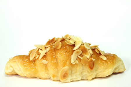A freshly baked almond croissant on whiteの写真素材