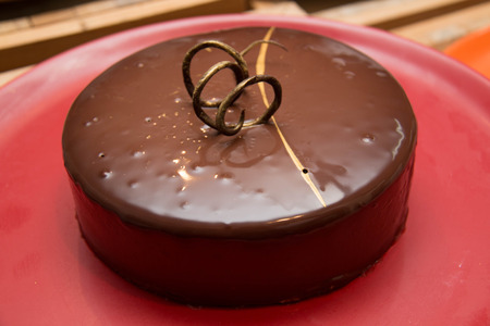 A Dark chocolate cake on red  plateの写真素材