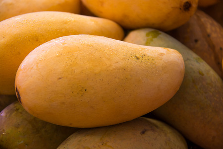 A Closeup of Yellow Mango on marketの写真素材