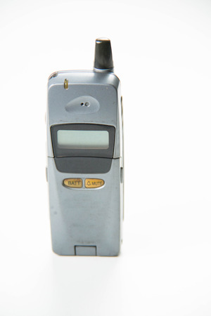 Solid color background and shabby gray old mobile phones.の写真素材