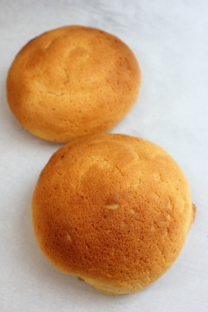 A Cheese bun on the white plate.
