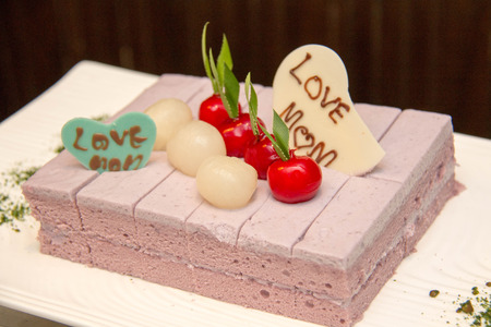Delicious cake with purple cream on it
