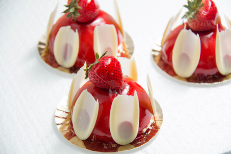 Strawberry cake in the glaze on a white backgroundの写真素材