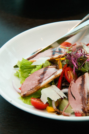 A Salad with arugula and duck breast.の写真素材