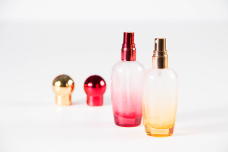 Closeup photo of a yellow and red perfume bottleの写真素材