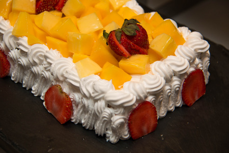 mango fancy cake with fresh  strawberry on  topの写真素材