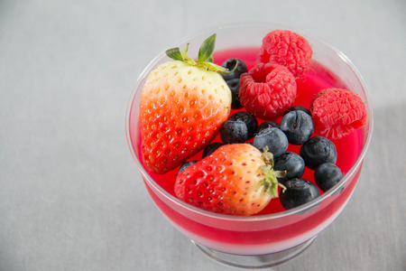 Three color jelly with fresh fruit in plastic cupの写真素材
