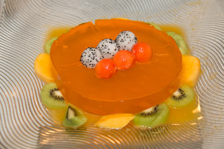 Fruit jelly in glass bowls with fresh raspberries