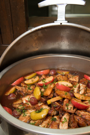 Roast pork slice with gravy sauce and fruit on top in dishの写真素材
