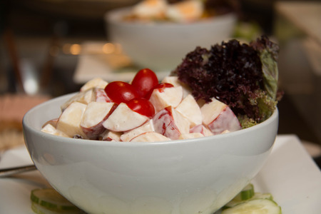 white bowl of mixed fruit and vegetables saladの写真素材