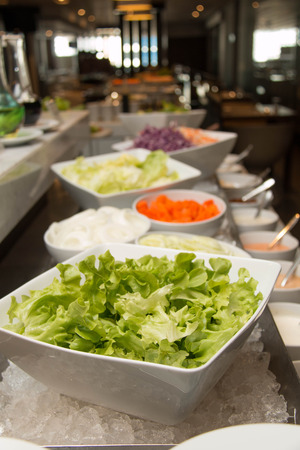 Counter with the vegetables prepared for saladsの写真素材