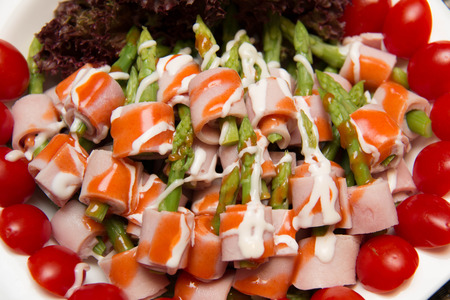 Dish of Ham and Asparagus Salad on white dishの写真素材