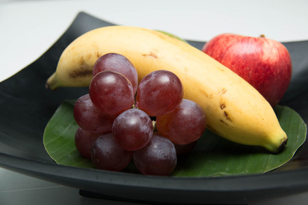 Fresh fruit in a wood bowl on a white backgroundの写真素材