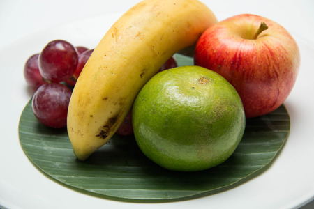 Fresh fruit in a plate on a white backgroundの写真素材