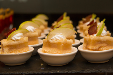 A cut mini apple  pie in mni white cup