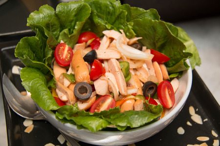 Fresh mixed vegetable salad with tomatoes, cucumbers, peppers sliced sausageの写真素材