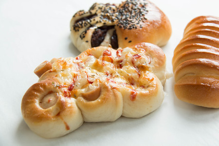 Assorted kinds of breads on a white backgroundの写真素材