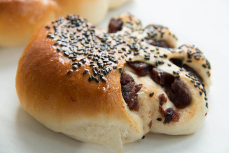 Red bean  bun topped with sesame seedsの写真素材