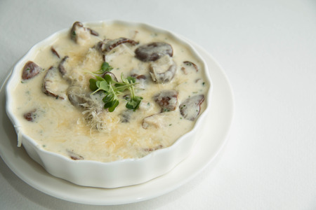 bake with cheese and cream sauce with mushroom in white dishの写真素材
