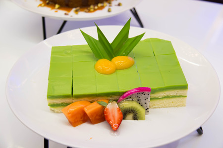 Sponge Cake Layered in Rich Pandan Kaya. With a grated coconut for the finishing.の写真素材