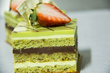 A pistacho layer cake and chocolate garnacheの写真素材