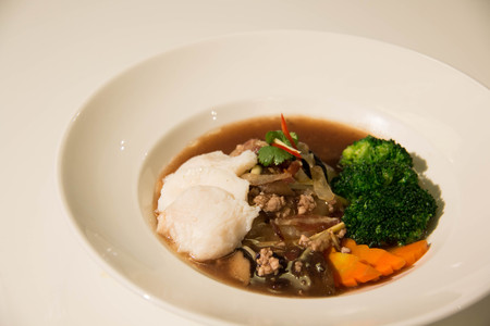 A Fried noodle with fish and broccoliの写真素材