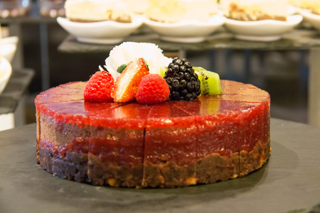 strawberry mousse cake decorated with raspberries, strawberry slices