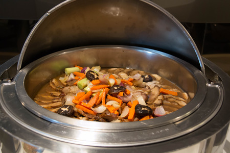 Roast pork with gravy sauce in dishの写真素材